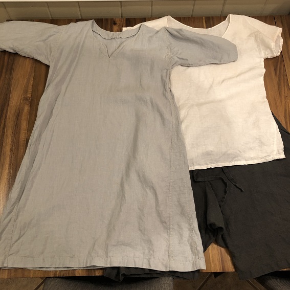 A grey tunic with yellow stitching